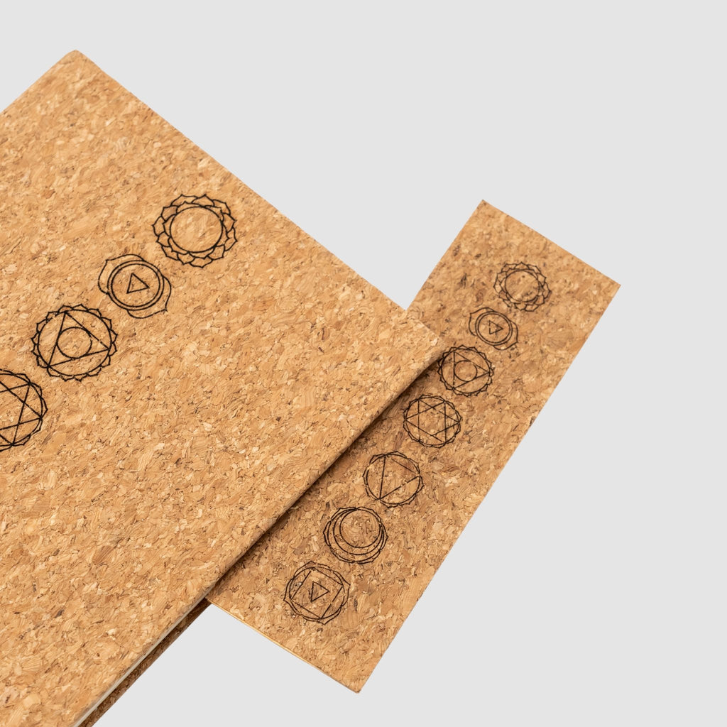 Cork notebook and bookmark with laser-engraved chakra design, on a white background
