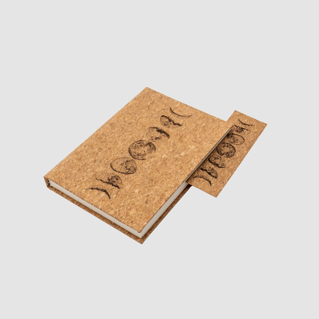 Cork notebook and bookmark with laser-engraved moon cycle design, on a white background