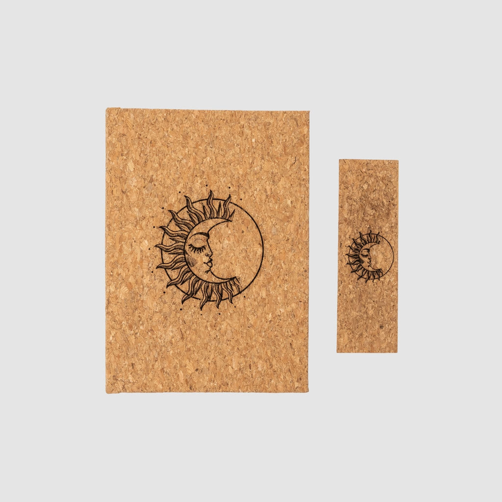 Cork notebook and bookmark with laser-engraved sun and moon design, on a white background