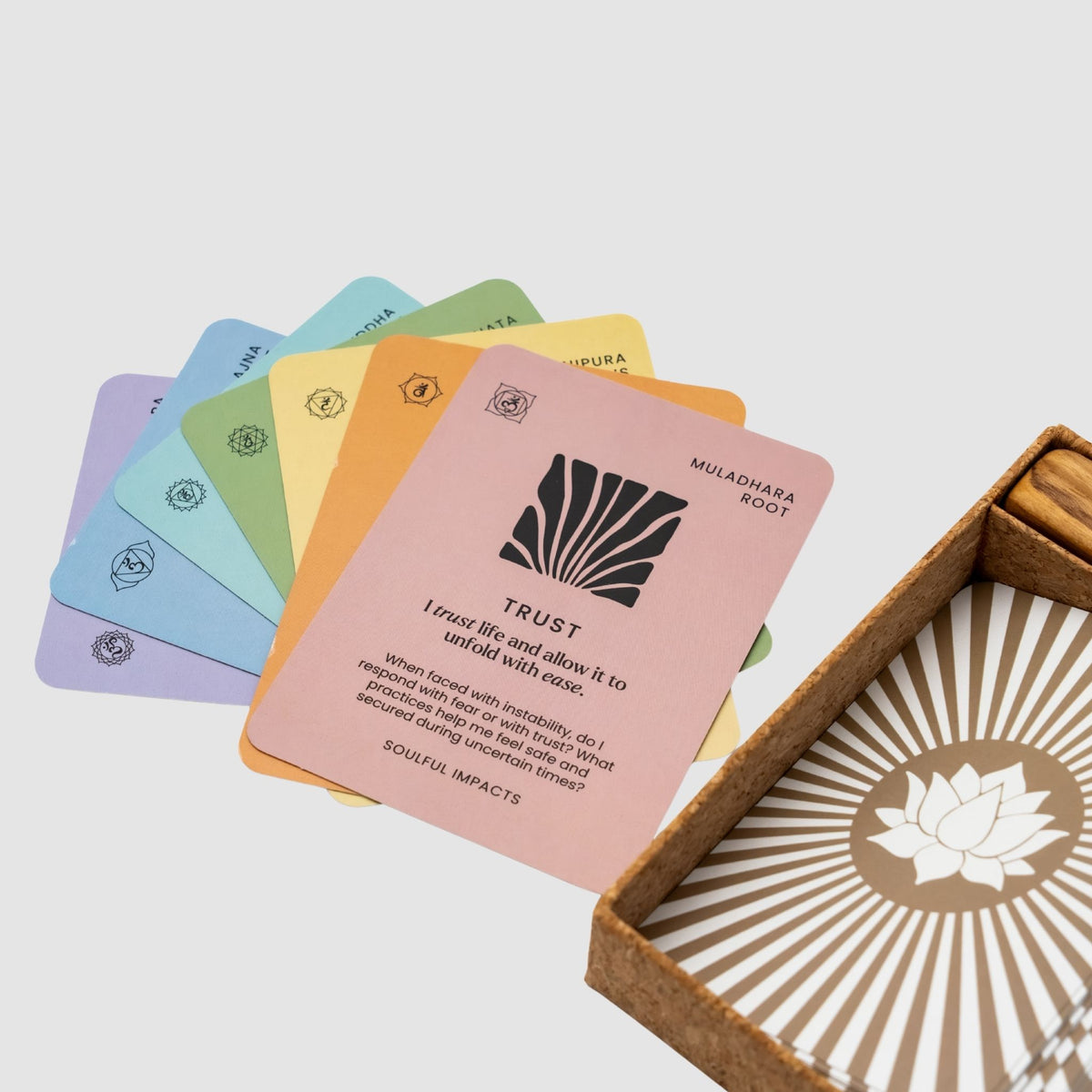 Set of colorful Chakra Affirmation Cards with an open box featuring a lotus design