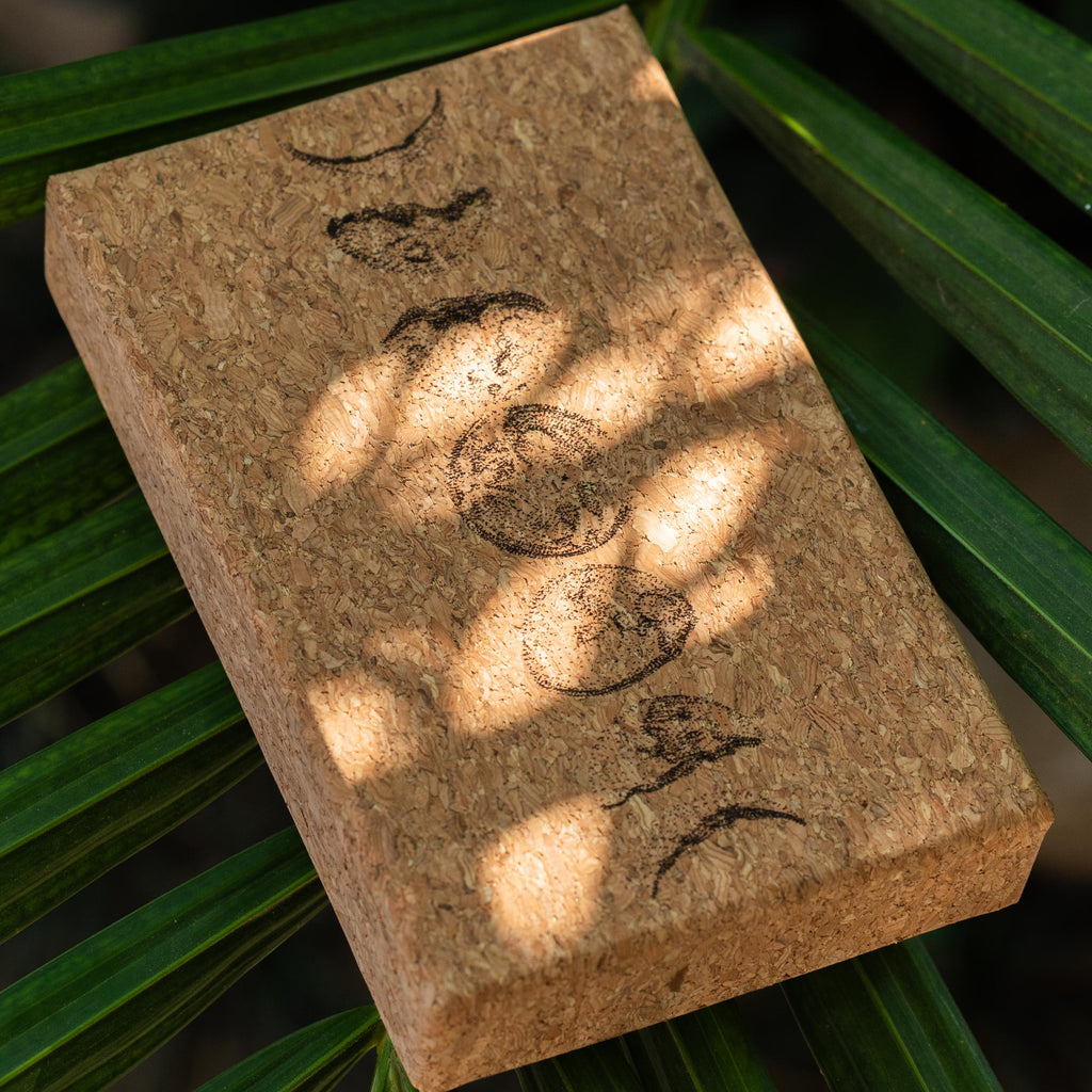 Moon Mantra Oracle Deck cork box resting on a leaf, handmade in Bali