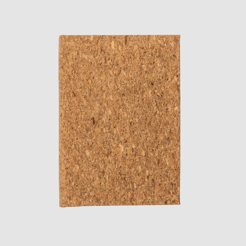Hardcover, blank, cork-based notebook, sitting on a white background