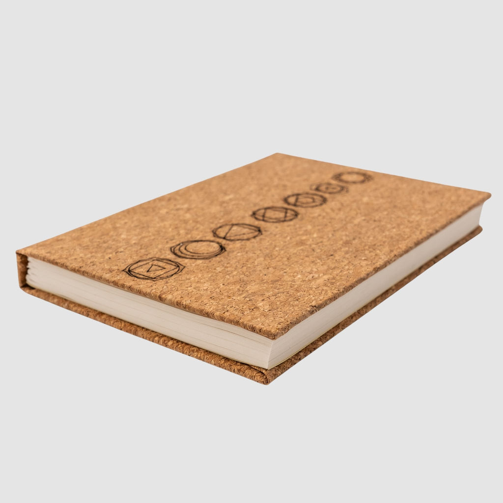 Cork hardcover blank notebook with chakra design, sitting tilted, on a white background