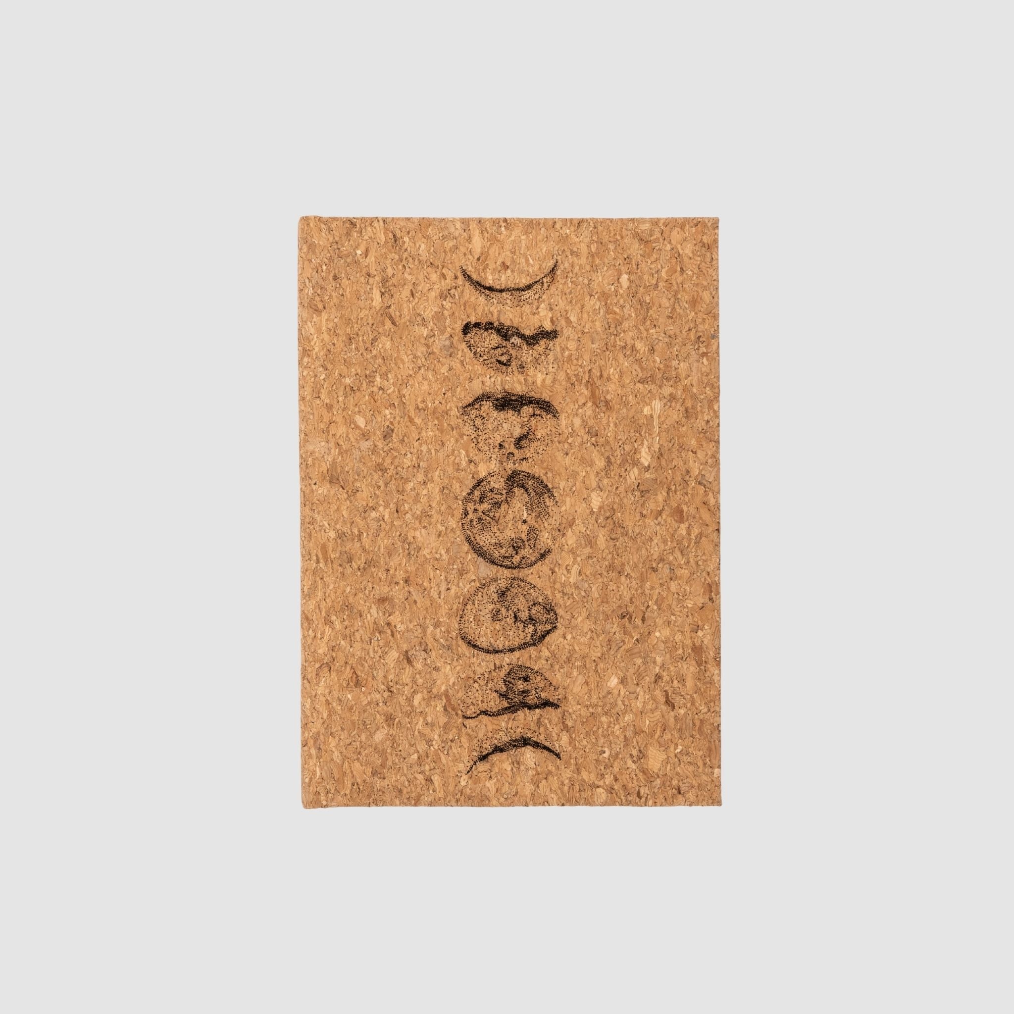 Cork hardcover blank notebook with moon cycle design, on a white background