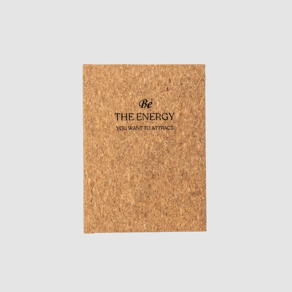 Cork-based planner with 'Be The Energy You Want To Attract' text laser-engraved design on front, sitting on a white background