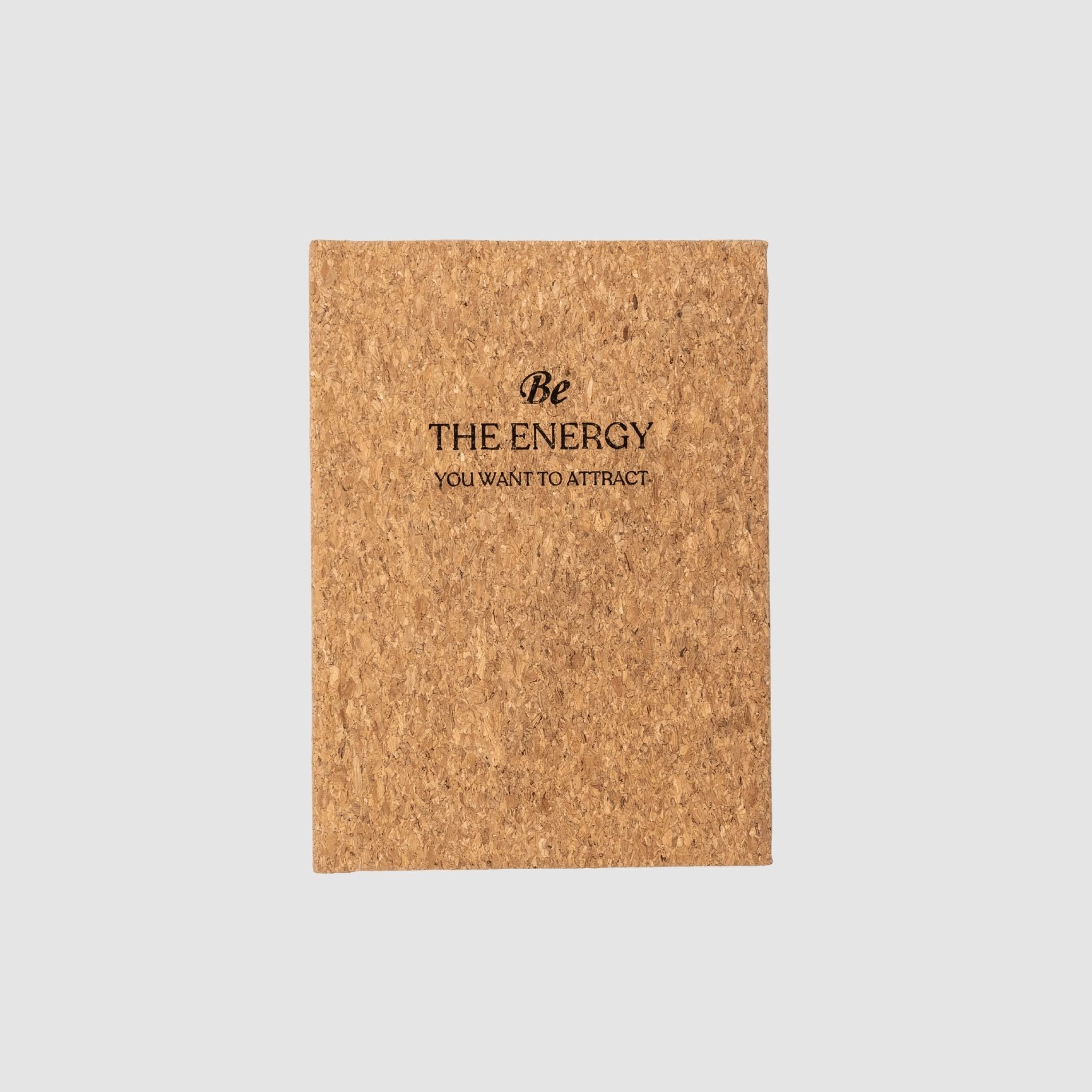 Cork-based planner with 'Be The Energy You Want To Attract' text laser-engraved design on front, sitting on a white background