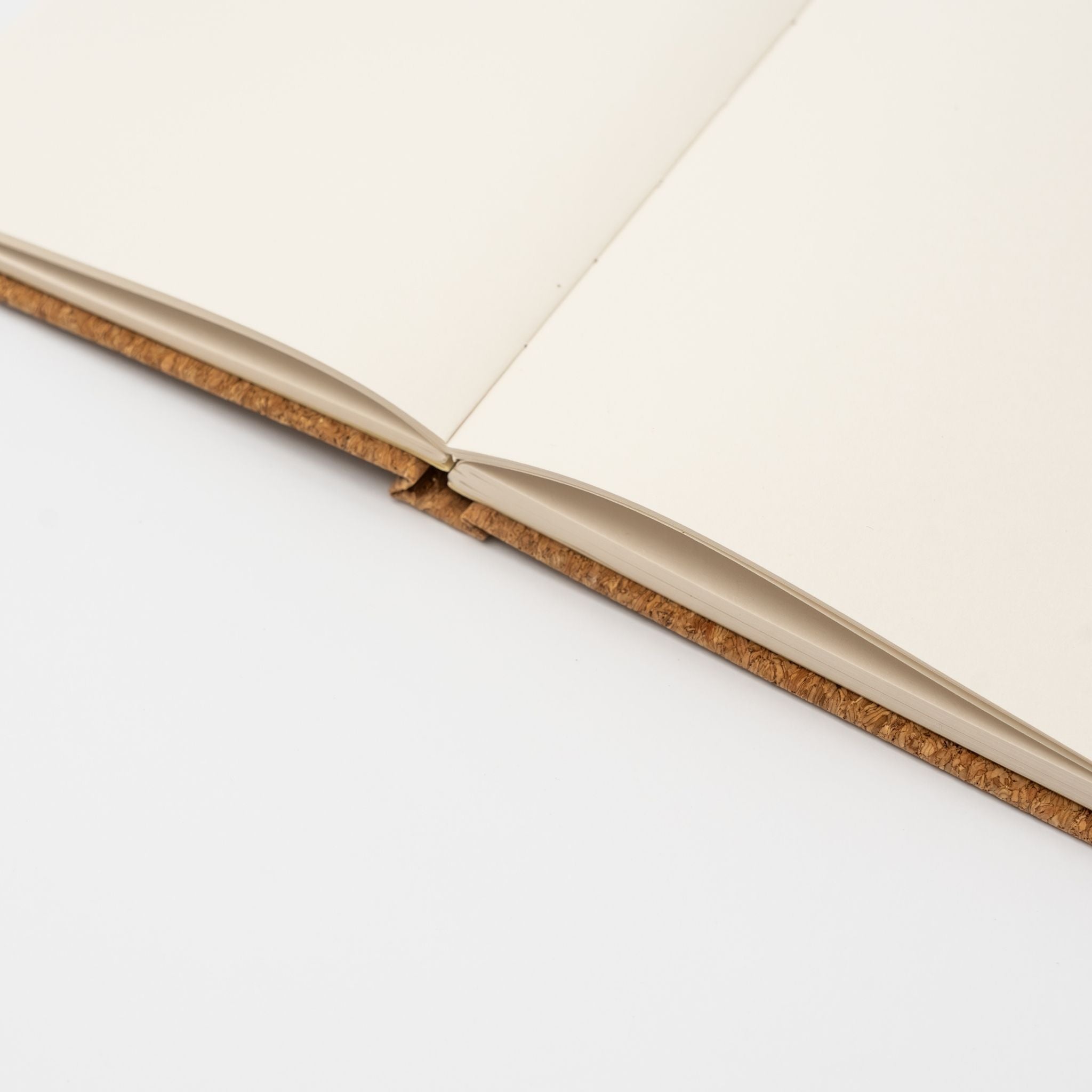 Open softcover notebook with a decorative edge on a white background